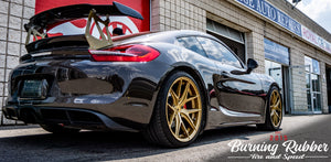 Black Porsche Cayman track car with new wheels and tires
